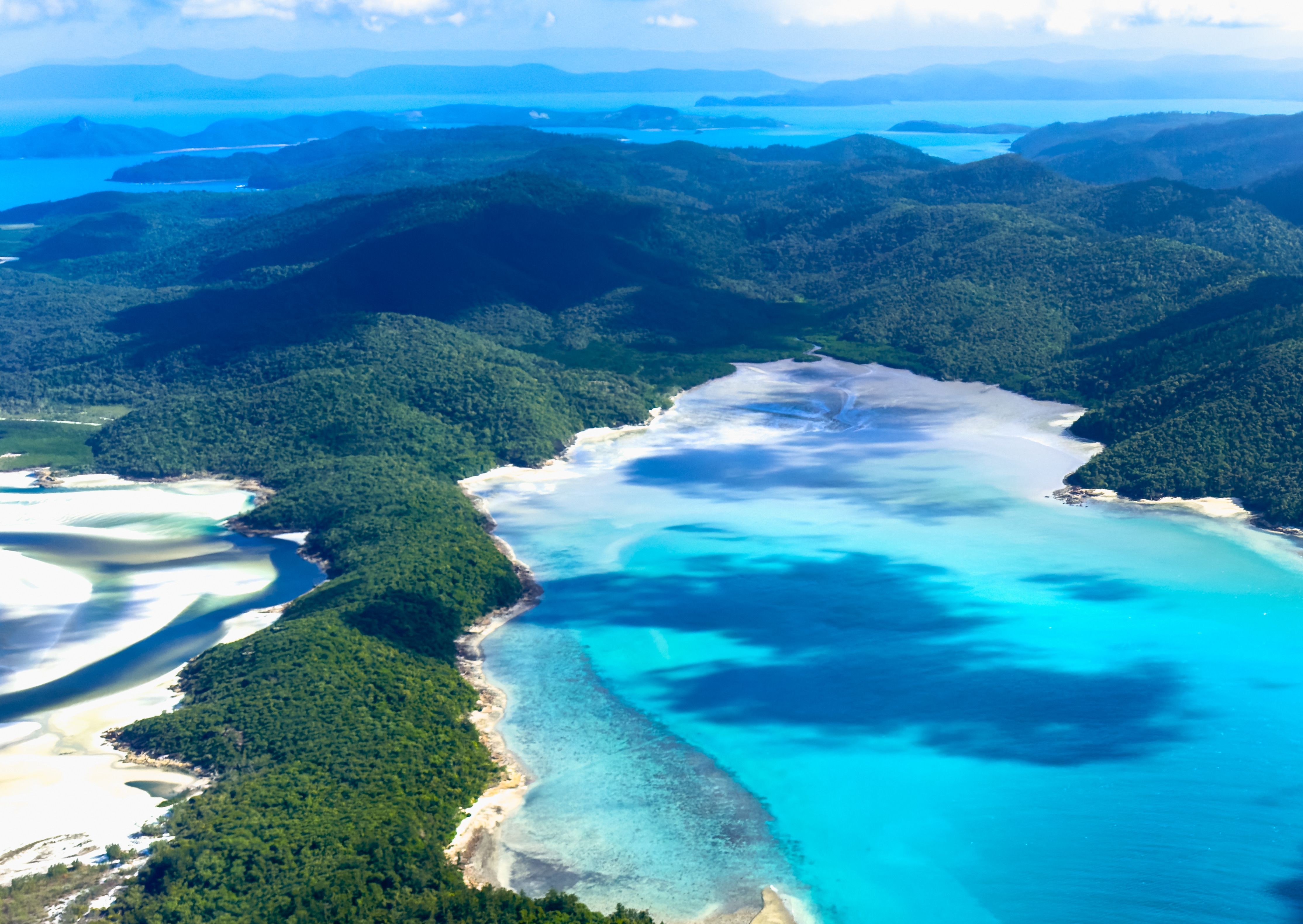 Aerial view of turquoise waters and tropical islands in the Whitsundays, Queensland